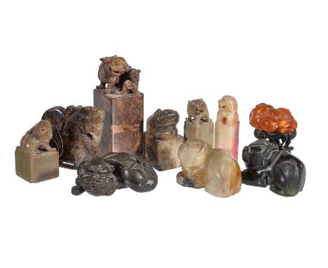 A white and black jade archaistic carving of a Buddhist lion, one side with veined brown inclusions and the other side with l