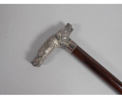 A Continental mahogany walking stick, the handle cast with a head of a wild boar and a hound in white metal, 92cm long.