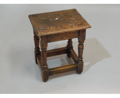 An oak joynt type stool, with a rectangular top, on turned supports, 37cm wide