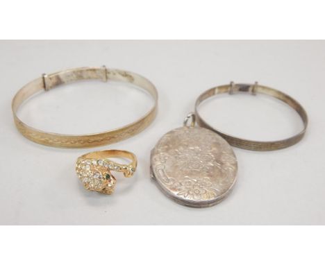 Three items of silver jewellery and a dress ring, to include two silver bangles, a silver locket and a gold plated leopard ri