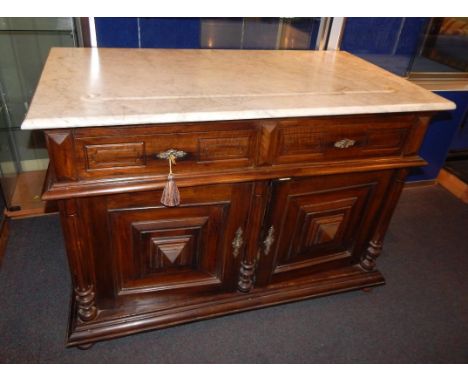 A Continental walnut commode, the rectangular white marble top with a recess, above two short drawers and two raised panel do