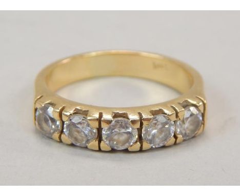 A diamond five stone dress ring, with five round brilliant cut stones, approx 0.12cts each, illusion set, on yellow metal ban