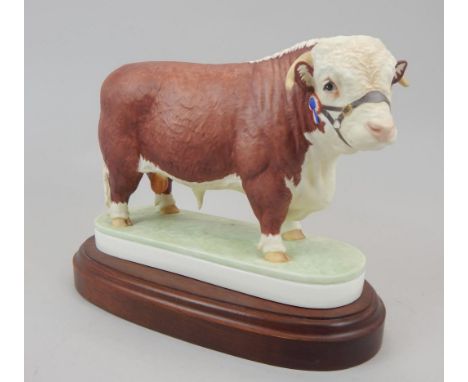 A Royal Worcester porcelain model of a Hereford Bull, modelled by Doris Lidner, on a mahogany base.