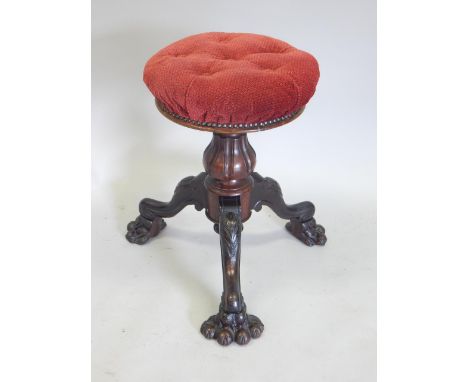 An unusual Victorian rosewood piano stool, by K Brooks & Co Limited, with a revolving padded seat, on a turned column, the ca