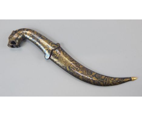 An Indian dagger, with curved blade, the scabbard and handle decorated with yellow metal, the pommel cast in the form of a ti
