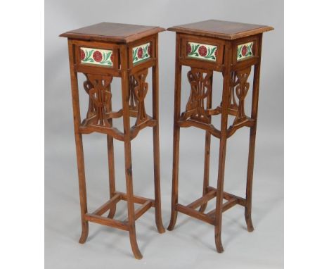 A pair of 20thC Art Nouveau style plant stands, each with a rectangular top above a frieze inset with ceramic panels and lyre