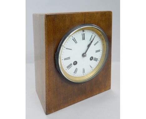 A late 19thC / early 20thC Continental mantel clock, with a white enamel dial, and a wedge shaped mahogany case, the case pos