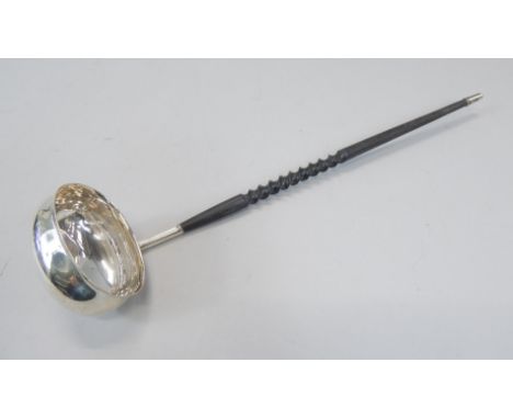 An 18thC style silver ladle, with a twisted handle Sheffield 1976. 