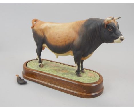 A Royal Worcester porcelain figure of a Jersey Bull, modelled by Doris Lidner, on a mahogany base, (AF).