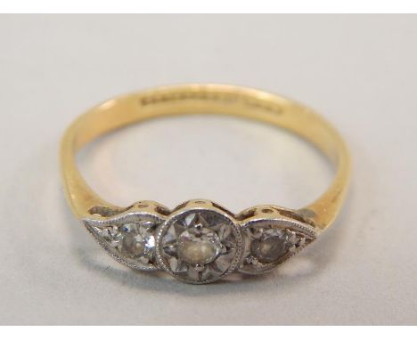 An Art Deco dress ring, set with three tiny diamonds, yellow metal, marked 18ct and plat, 1.7g all in. 