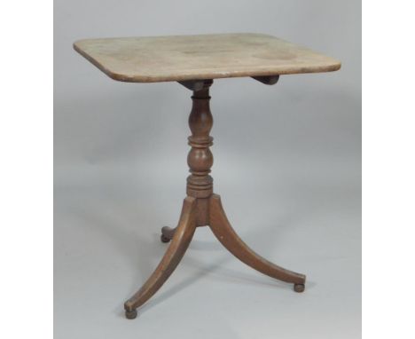 An early 19thC mahogany occasional table, the rectangular tilt top on a turned column and tripod base, 85cm wide.