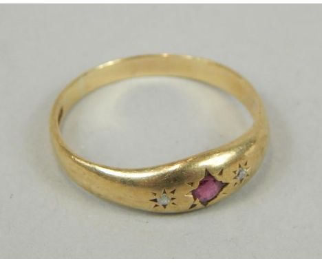 An 18ct gold ruby and diamond dress ring, with three illusion set stone.