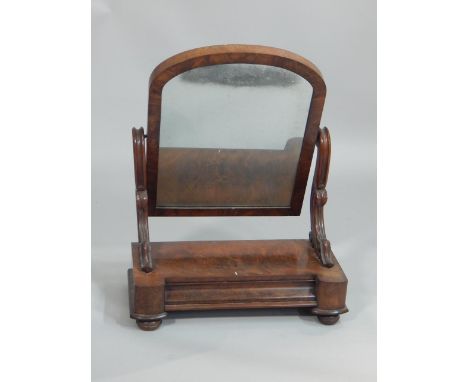 A Victorian mahogany dressing table mirror, with an arched plate, on shaped supports, the base with a concave frieze drawer, 