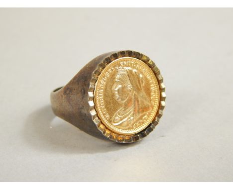 A gentleman's chunky ring, set with mock Victorian sovereign, plain surround, unmarked, yellow metal