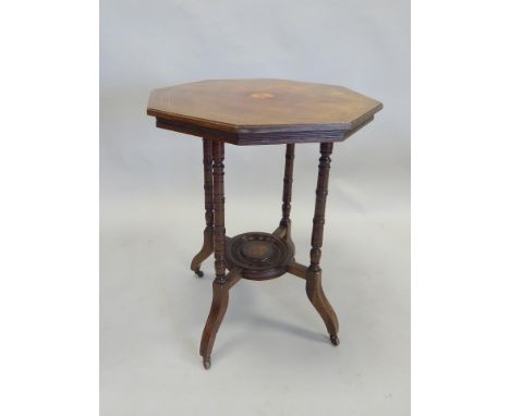 An Edwardian walnut two tier occasional table, the octagonal top with a central fan inlay, on turned supports with splayed le