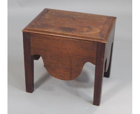 A George III mahogany commode, the hinged lid with a moulded edge, the base with a shaped apron, lacking ceramic insert, 43cm