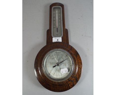 An Art Deco Oak Wall Barometer with Temperature Scale.