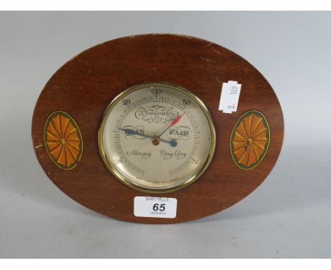 An Oval Wall Barometer with Shell Decoration by Short and Mason, London. 