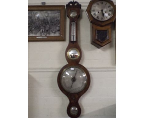 A 19th Century Wheel Barometer with Temperature Scale by Thomson Harrold. 