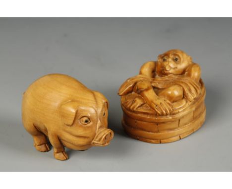 TWO JAPANESE WOOD NETSUKE, one of a pig, the other a monkey, 20th century, 2" long (2)