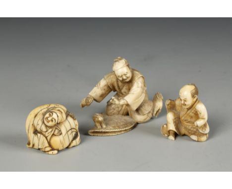 A JAPANESE IVORY NETSUKE AND TWO FIGURES, the netsuke of a man holding a sack, late Edo/Meiji, 1.5" across; one figure showin