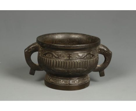 A CHINESE BRONZE BOMBE CENSER with archaistic dragon-scroll decoration and self-consuming mask handles, Qing, c.610grams, 5.5