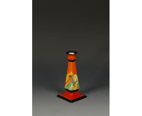 A CLARICE CLIFF APPLIQUE BIZARRE SQUARE CANDLESTICK decorated against an orange ground with the "Lucerne" pattern, with black