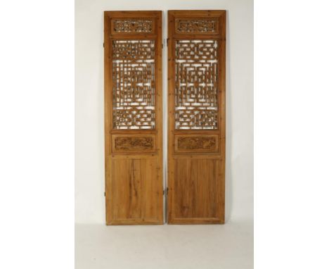 FOUR CHINESE SOFTWOOD ARCHITECTURAL PANELS, each with an openwork scroll and foliate area above central carved landscape pane