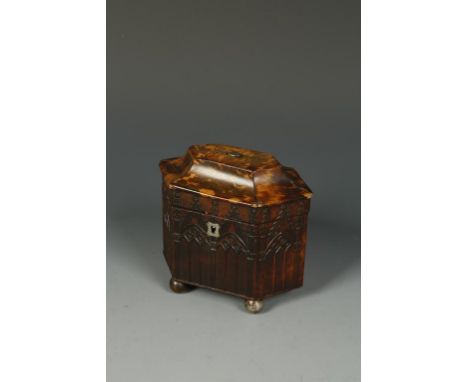 A LATE GEORGE III TORTOISESHELL VENEERED TEA CADDY, of elongated hexagonal form with a raised top, the sides with pressed Got