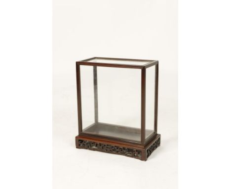 A CHINESE HONGMU GLAZED DISPLAY CASE of plain form with an openwork scroll base, 20th century, 16.5" high.  Provenance: The C