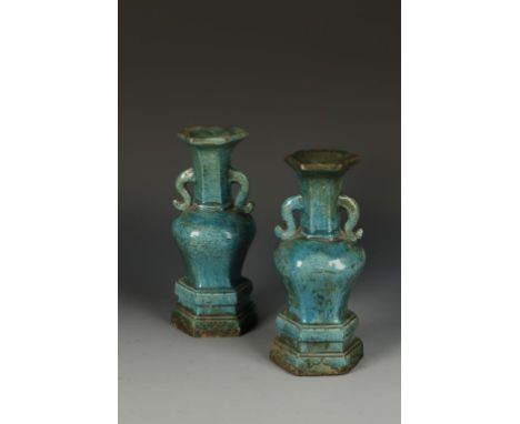 A PAIR OF CHINESE TURQUOISE-GLAZED HEXAGONAL VASES, the flared necks and scroll handles above a tapering body and stepped bas