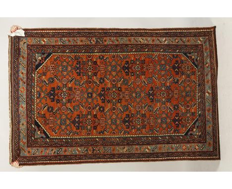 A PAIR OF NORTH-WEST PERSIAN TRIBAL RUGS, the central rectangular brick red panel worked with multi-coloured diamond quadrila