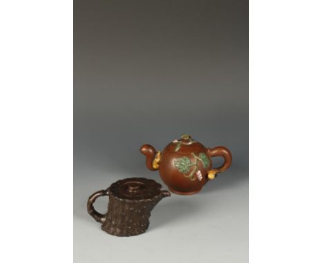 TWO CHINESE YIXING TEAPOTS, one of darker clay in the form of a lotus pod, signed "Gu Jing Zhou", 5.5" long; the other modell