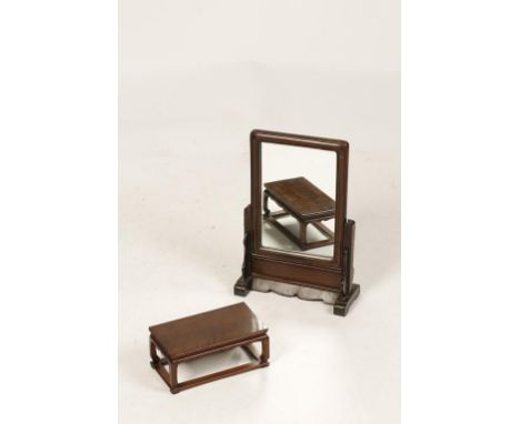 A CHINESE NANMU SMALL STAND AND A TABLE SCREEN/MIRROR, the stand of waisted rectangular form with scroll aprons, late Qing/Re