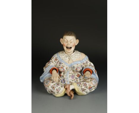 A MEISSEN STYLE CONTINENTAL PORCELAIN MODEL OF A SEATED CHINESE WOMAN, with legs crossed and hands spreading for meditation, 