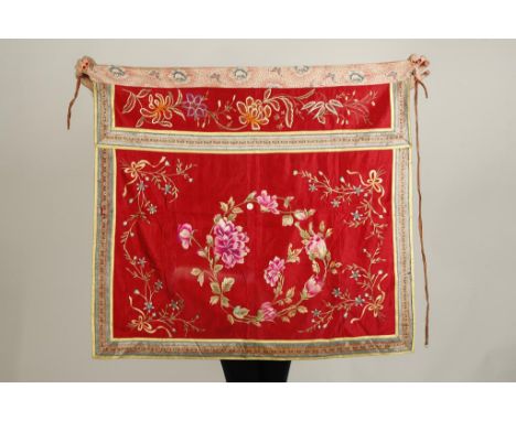 TWO CHINESE SILK-EMBROIDERED PANELS, the larger example showing peonies on a red ground with a foliate band above, late Qing/