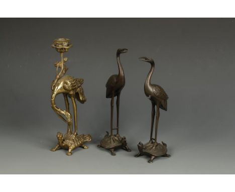 THREE JAPANESE BRONZE CRANES, all standing on a tortoise, the larger example formed as a candlestick, 10.5" high, all Meiji/T