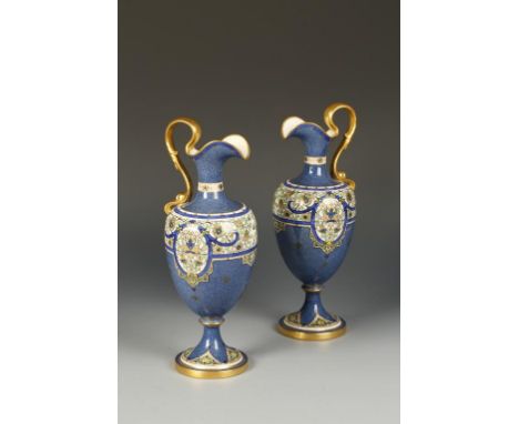 A PAIR OF VICTORIAN ROYAL WORCESTER PORCELAIN EWERS of classical form, with gilt scroll handles and Persian style painted flo