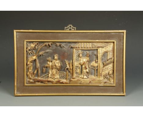 A CHINESE GILTWOOD PANEL showing two ladies in a pavilion with a man outside, late Qing/Republic, 11" x 19" overall