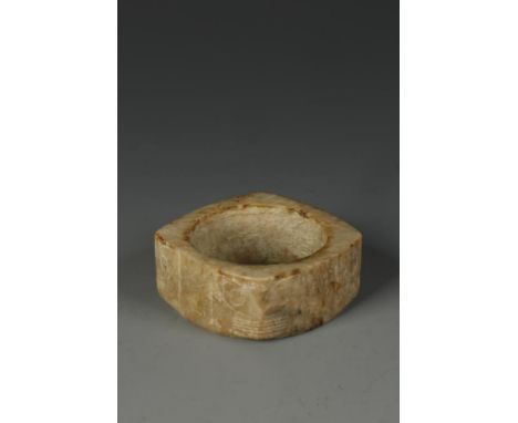 A CHINESE JADE CONG, each corner carved with a stylised mask, the mottled brownish stone with some darker markings, Ming, 3.2