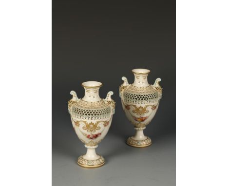 A PAIR OF EARLY 20TH CENTURY ROYAL WORCESTER PORCELAIN VASES by George Owen dated 1913, of urn-shape with twin scrolled and r