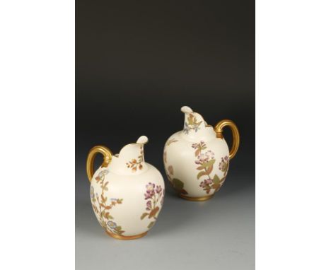A PAIR OF VICTORIAN ROYAL WORCESTER PORCELAIN EWERS with moulded gilt handles and painted floral decoration, stamped to the u
