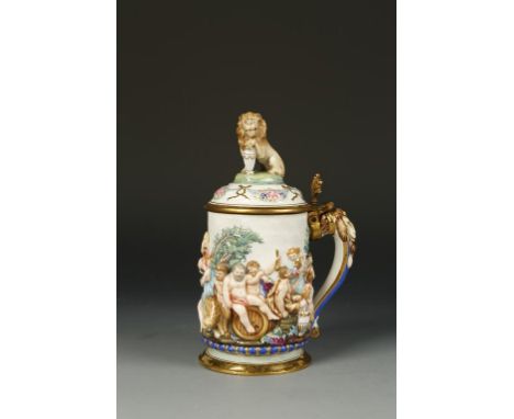 A NAPLES 'CAPODIMONTE' TANKARD AND COVER, moulded in relief with Bacchanalian classical figures celebrating, in polychrome wi