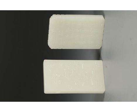 TWO CHINESE WHITE JADE PENDANTS, one carved in low relief with calligraphy and scholars in a landscape, 2.25" long, the other