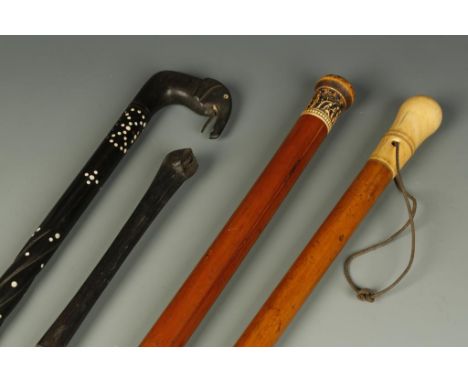 A SRI LANKAN EBONY AND IVORY DOT WALKING STICK, with elephants head handle and carved shaft, 36", two ivory headed canes and 