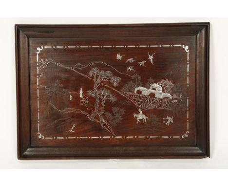 A CHINESE SILVER-INLAID HARDWOOD PANEL showing figures and buildings in a landscape, late Qing/Republic, 14.5" x 20.5"
