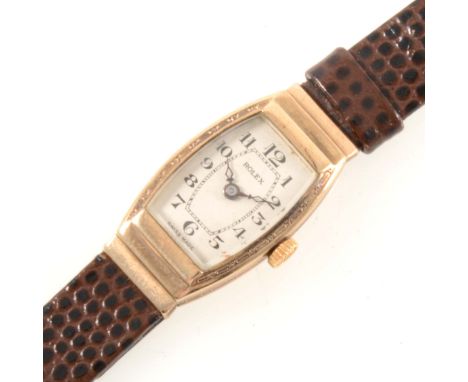 Rolex - A lady's 9 carat yellow gold wrist watch, cream tonneau shaped arabic dial in a 9 carat yellow gold rectangular stepp