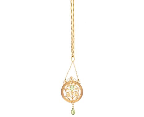 An Edwardian peridot and seed pearl pendant and chain, the yellow metal 23mm circular frame marked 9ct by H&amp;N having a le