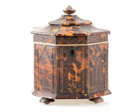 A William IV tortoiseshell octagonal shape tea caddy, hinged casket top, press moulded decoration of Gothic niches, some loss