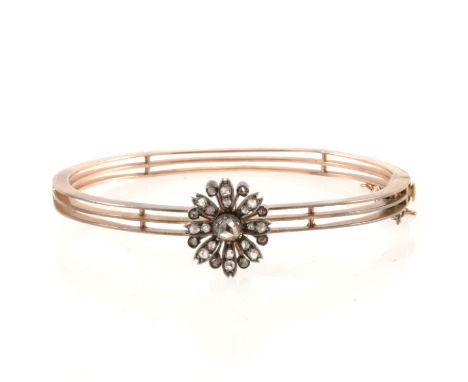 A diamond set half hinged bangle, twenty-five rose cut diamonds set as a floral cluster in white metal testing as silver on a